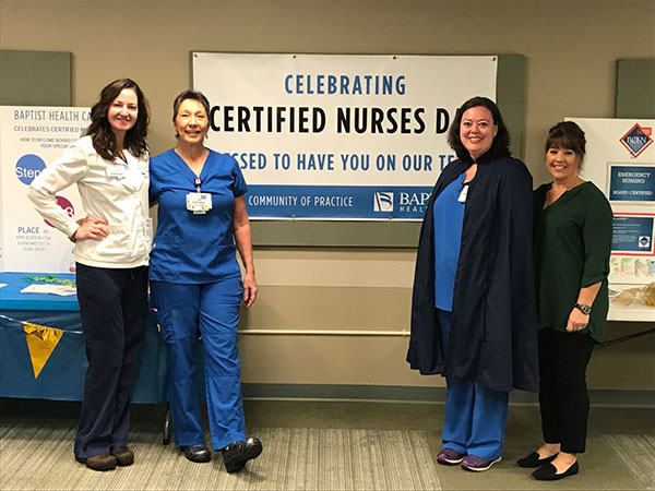 Nursing professionals standing in front of sign that says Celebrating Certified Nurses Day